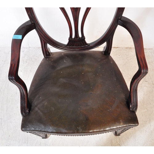 1745 - A 19th Century Arts & Craft dark mahogany dining / hall chair. With an arched top with shield back r... 