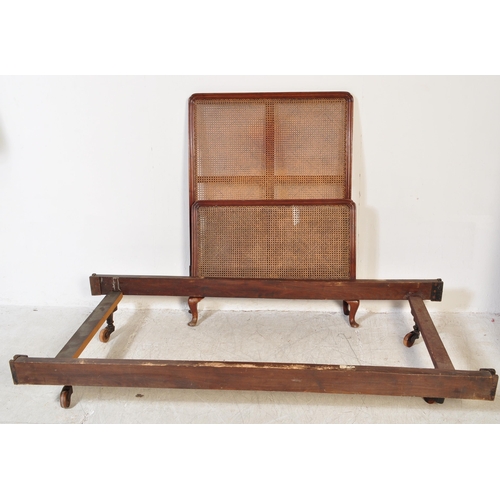 1747 - A early 20th Century Bergere mahogany bed frame. Having a curved threaded frame around cane / wicker... 