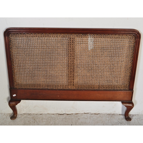 1747 - A early 20th Century Bergere mahogany bed frame. Having a curved threaded frame around cane / wicker... 