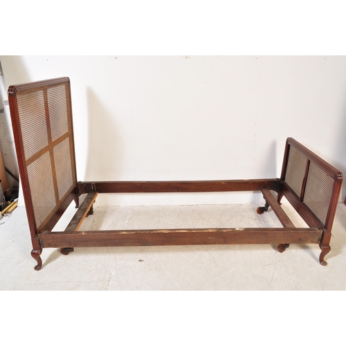 1747 - A early 20th Century Bergere mahogany bed frame. Having a curved threaded frame around cane / wicker... 