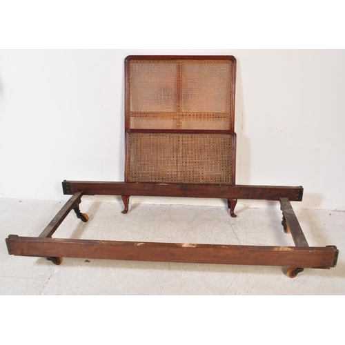 1748 - An early 20th Century Bergere mahogany bed frames. Having a curved threaded frame around cane / wick... 