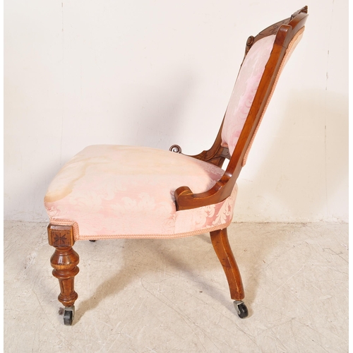 1749 - An early 20th Century mahogany nursing chair. The chair frame carved with foliate motifs and the sea... 