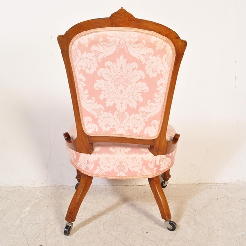 1749 - An early 20th Century mahogany nursing chair. The chair frame carved with foliate motifs and the sea... 