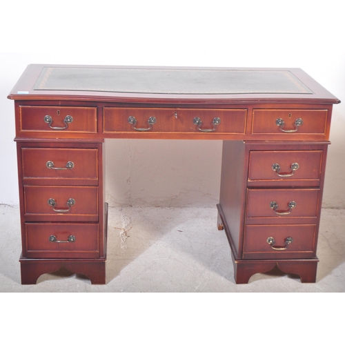 1751 - A 20th century mahogany twin pedestal office desk having a shaped top with central green leather pan... 