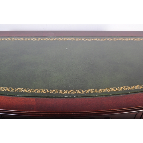 1751 - A 20th century mahogany twin pedestal office desk having a shaped top with central green leather pan... 