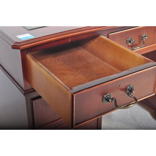 1751 - A 20th century mahogany twin pedestal office desk having a shaped top with central green leather pan... 