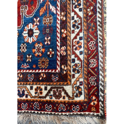 1754 - An vintage mid 20th century circa 1950s Persian Islamic Qashqai floor carpet rug having graduating c... 