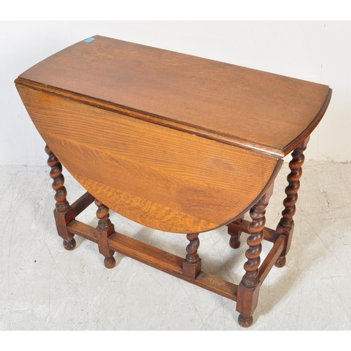 1757 - A 19th Century Victorian oak gateleg table with x2 drop leaves. The table having two swing out gate ... 