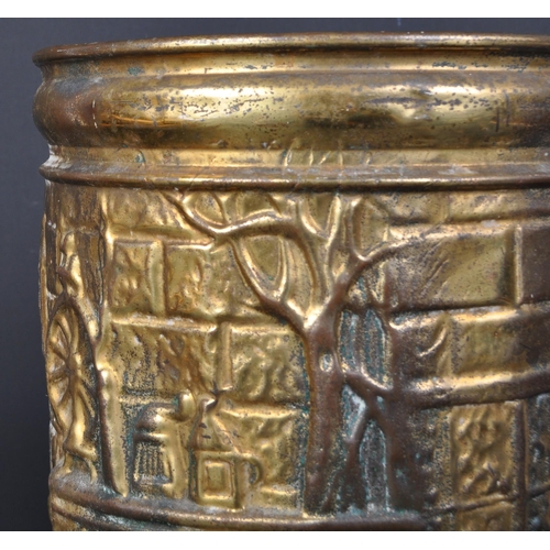 1769 - An early 20th century brass umbrella stand being of cylindrical form with repousse decoration to dep... 