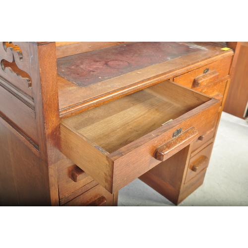 1773 - 1920's oak Arts & Crafts twin pedestal desk having pierced gallery surround top with leather inset o... 