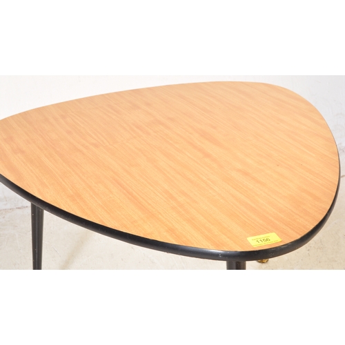 1254 - A retro mid 20th century teak veneer coffee table in a triangular form. Having ebonised angular tape... 