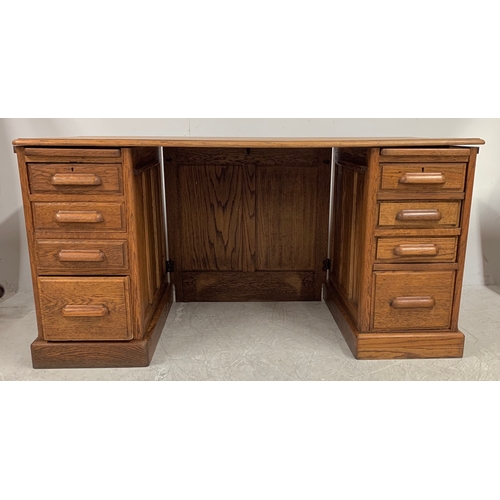 1738 - A vintage early 20th Century golden oak twin pedestal desk. Having a bank of four graduating drawers... 