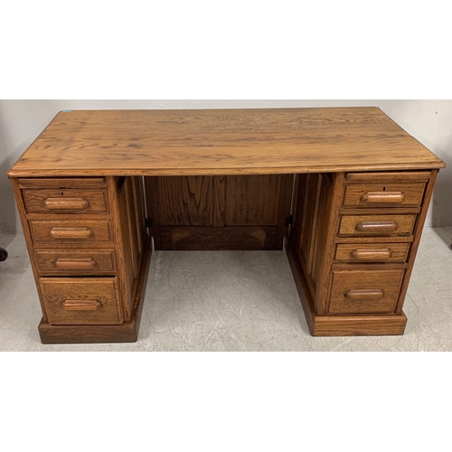 1738 - A vintage early 20th Century golden oak twin pedestal desk. Having a bank of four graduating drawers... 