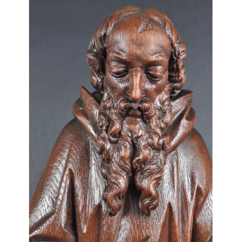 119 - A 20th century carved seated statue of Saint Jerome. An ornately carved with fine detailing, posed s... 