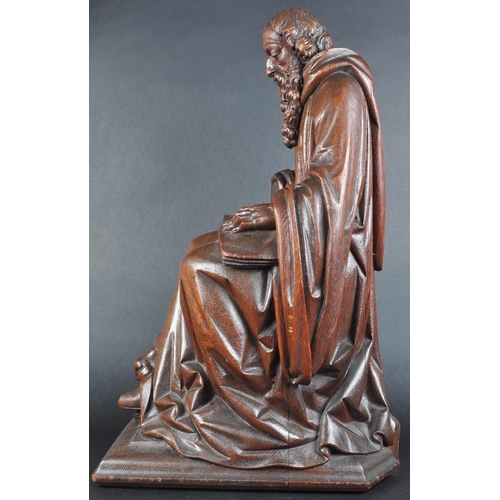 119 - A 20th century carved seated statue of Saint Jerome. An ornately carved with fine detailing, posed s... 