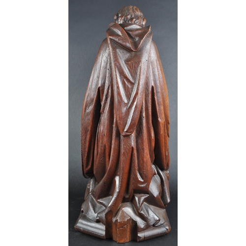 119 - A 20th century carved seated statue of Saint Jerome. An ornately carved with fine detailing, posed s... 