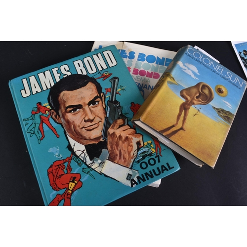 19 - A large collection of assorted James Bond related vintage books.  Titles to include: Colonel Sun by ... 