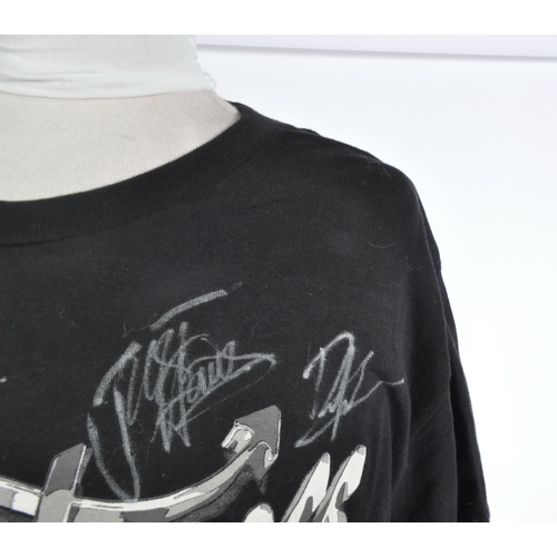 266 - The Darkness - an autographed t-shirt by the band, including Justin and Dan Hawkins. All signed in s... 