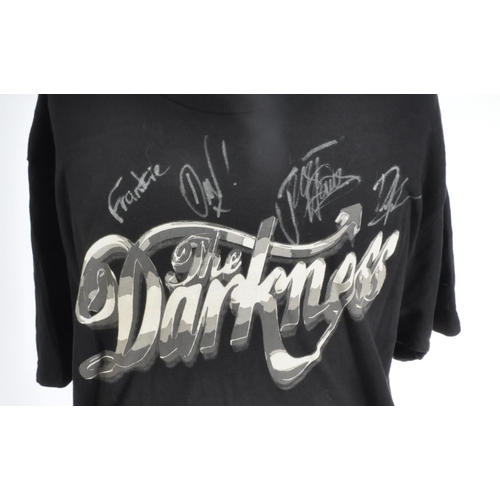 266 - The Darkness - an autographed t-shirt by the band, including Justin and Dan Hawkins. All signed in s... 