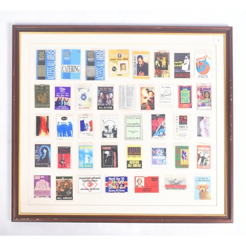 90 - Music Memorabilia - Backstage Passes - a large framed display of assorted backstage passes from vari... 