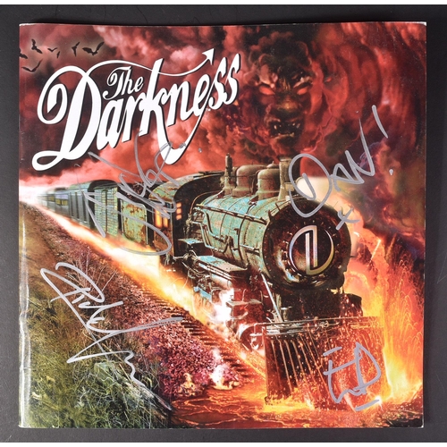 92 - The Darkness - an autographed tour programme by the band, including Justin and Dan Hawkins. All sign... 