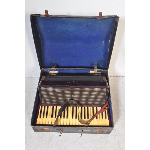 1114 - A vintage 20th century circa. 1940's Hohner accordion musical instrument having red Lucite type case... 