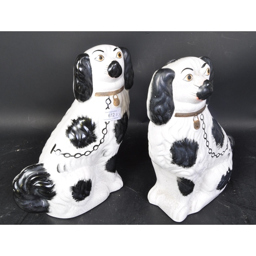 612 - A pair of 19th century late Victorian bone china mantel fireside dogs. Each being hand painted with ... 