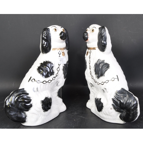 612 - A pair of 19th century late Victorian bone china mantel fireside dogs. Each being hand painted with ... 