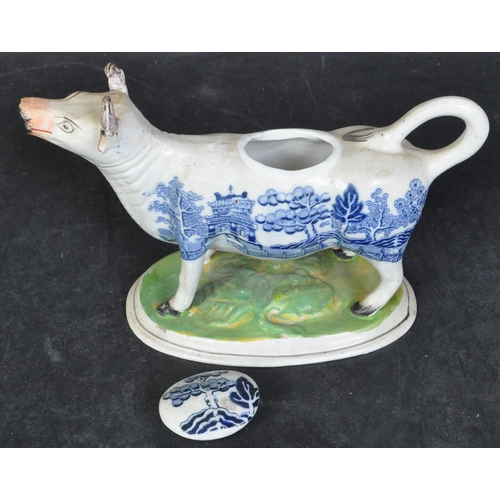 615A - A 19th century Staffordshire porcelain cow creamer. Blue and white willow pattern to the body with g... 