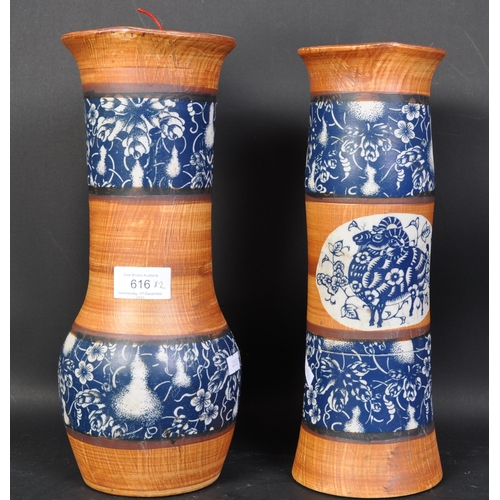 616 - A pair of 20th century Chinese pottery gu vases, decorated with banded vignettes of animals, flora a... 