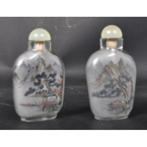 624 - A pair of early 20th century hand painted Chinese glass perfume scent bottles. Each to depict landsc... 