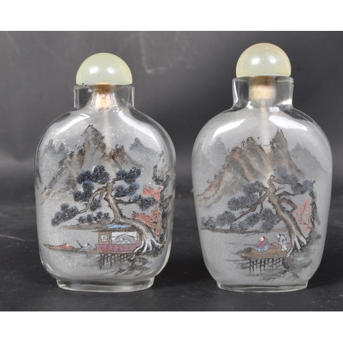 624 - A pair of early 20th century hand painted Chinese glass perfume scent bottles. Each to depict landsc... 