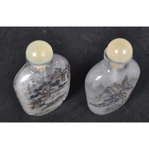 624 - A pair of early 20th century hand painted Chinese glass perfume scent bottles. Each to depict landsc... 