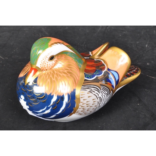 631 - A Royal Crown Derby mandarin duck. With gilt and polychrome decoration. With gilt stopper and makers... 