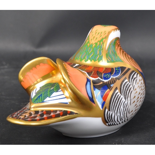 631 - A Royal Crown Derby mandarin duck. With gilt and polychrome decoration. With gilt stopper and makers... 