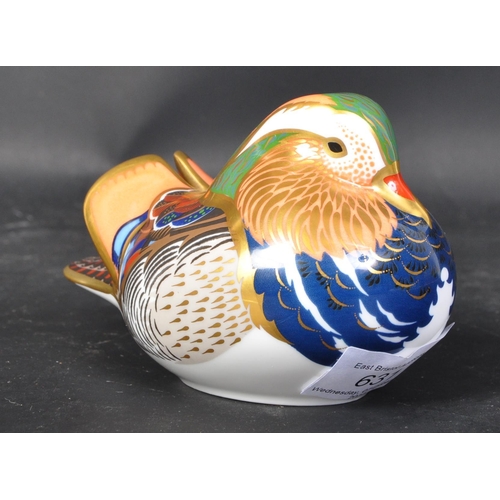 631 - A Royal Crown Derby mandarin duck. With gilt and polychrome decoration. With gilt stopper and makers... 