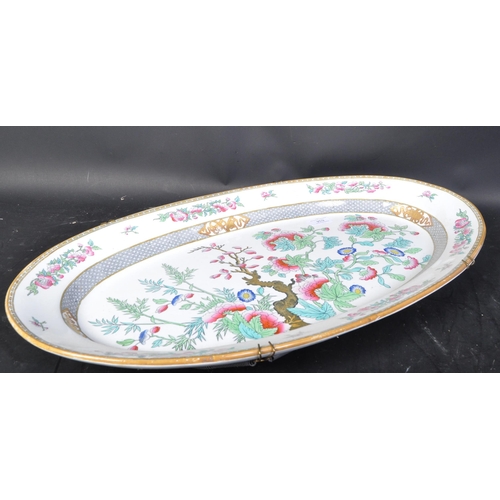 634 - A large early 20th century Indian Tree pattern meat platter of oval form with gilt decoration to sur... 