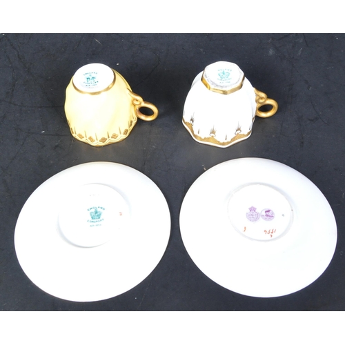 635A - Two early 20th century Coalport & Royal Worcester porcelain coffee cups & saucers. The lot to includ... 