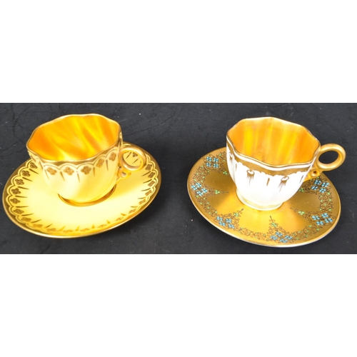 635A - Two early 20th century Coalport & Royal Worcester porcelain coffee cups & saucers. The lot to includ... 