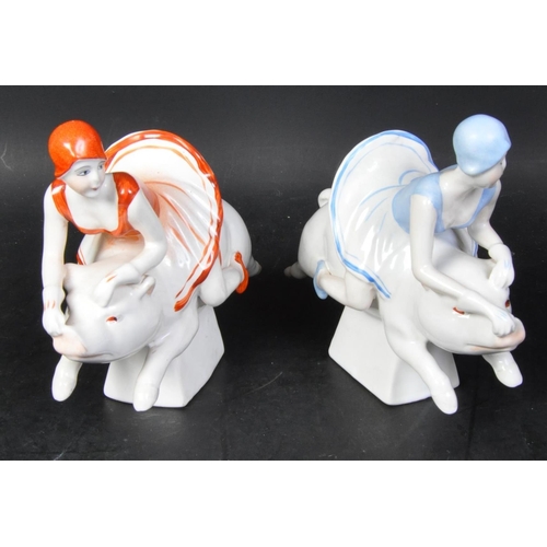 636A - A pair of 20th century Art Deco style ceramic bookends in the shape of two ladies riding pigs. One i... 