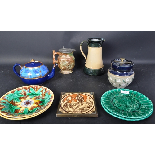 654 - A Collection of ceramics to include Aesop's Fable tile, majolica plates, Victorian teapot, Doulton L... 