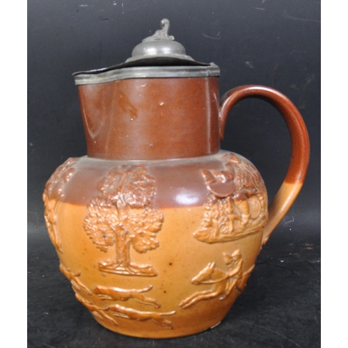 662 - A Victorian 19th century Royal Doulton stoneware Harvest jug with silver mounted rim and lid of bulb... 