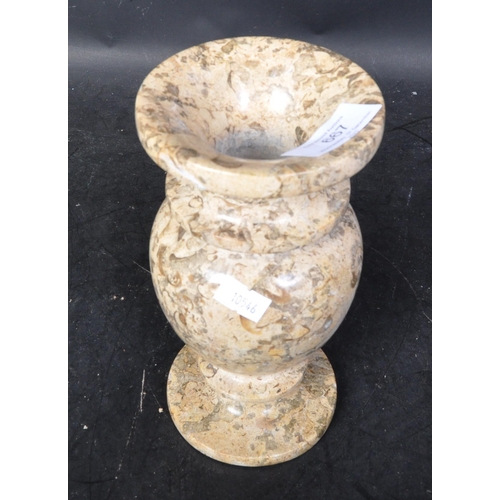 667 - A vintage 20th Century marble vase. Of circular form with a tapering rim bulbous body and round base... 