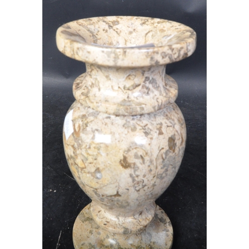 667 - A vintage 20th Century marble vase. Of circular form with a tapering rim bulbous body and round base... 