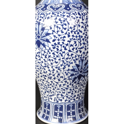 671 - A large vintage 20th century Chinese blue and white vase of baluster form. The vase having florals a... 