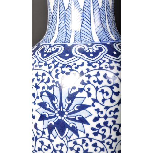 671 - A large vintage 20th century Chinese blue and white vase of baluster form. The vase having florals a... 