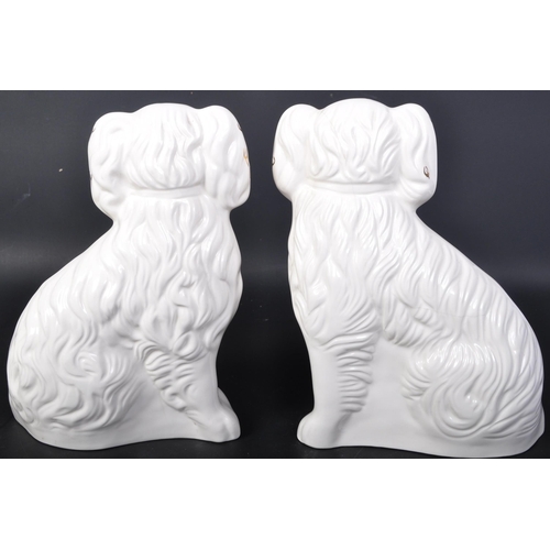 681 - A pair of Beswick English Staffordshire style ceramic dogs. In a seating position with gilt detailin... 