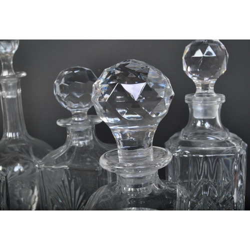 688 - A collection of five vintage 20th century cut glass decanters. The collection to include a Stuart Cr... 