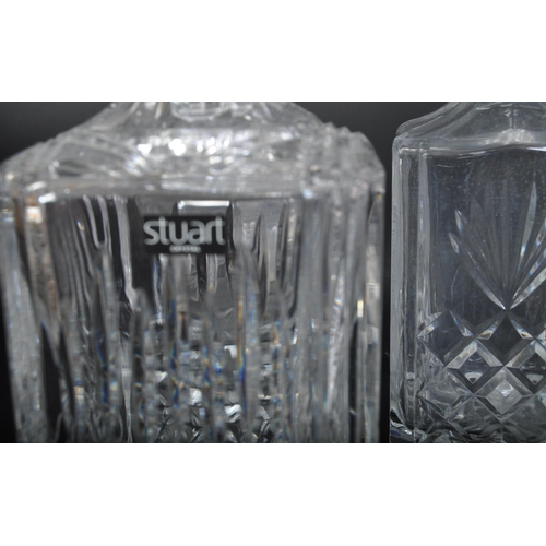 688 - A collection of five vintage 20th century cut glass decanters. The collection to include a Stuart Cr... 