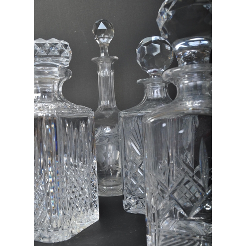 688 - A collection of five vintage 20th century cut glass decanters. The collection to include a Stuart Cr... 